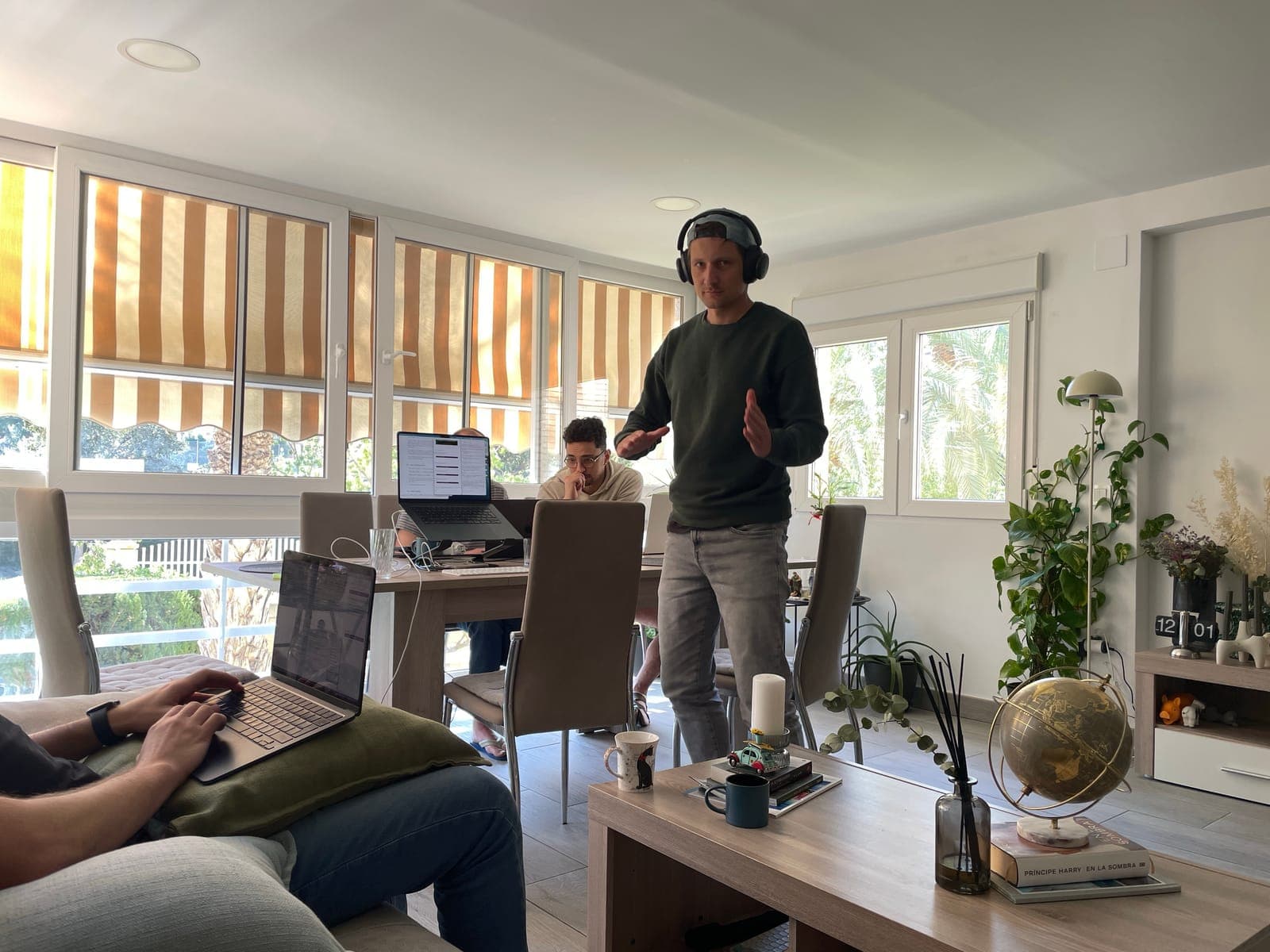 People with laptops around a dining table