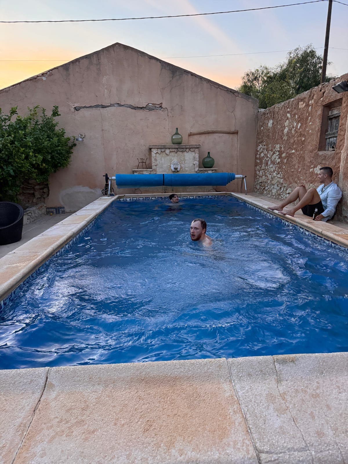 People in and beside an outdoor pool